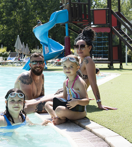 Happy family at the pool, smiles and fun under the summer sun.