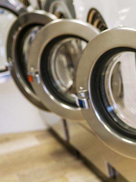 Row of industrial washing machines, order and cleanliness in a modern setting.