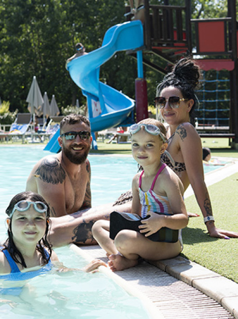 Happy family at the pool, smiles and fun under the summer sun.